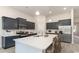 Spacious kitchen with stainless steel appliances, an island with seating, and modern lighting fixtures at 846 Ireland Dr., Longs, SC 29568
