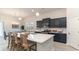 Open-concept kitchen with dark cabinets, island seating, and a view into the adjacent dining area at 846 Ireland Dr., Longs, SC 29568