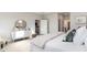 Sunlit main bedroom boasting a decorative mirror, chic dresser, and comfortable furnishings at 846 Ireland Dr., Longs, SC 29568