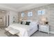 Bright main bedroom featuring decorative wallpaper, tray ceiling, and plenty of natural light at 846 Ireland Dr., Longs, SC 29568
