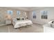 Serene main bedroom with elegant wallpaper, tray ceiling, and bright windows offering a tranquil retreat at 846 Ireland Dr., Longs, SC 29568