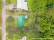 Aerial view of a home with mature trees, a green metal roof and an outlined lot at 96 Middleton Rd., Andrews, SC 29510