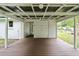 Covered back porch with painted wood flooring and a view of the spacious backyard at 96 Middleton Rd., Andrews, SC 29510