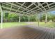 Covered back porch with a wooden deck, views of the backyard and nearby trees at 96 Middleton Rd., Andrews, SC 29510