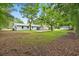 Spacious backyard featuring mature trees, with a concrete pad and various storage sheds at 96 Middleton Rd., Andrews, SC 29510