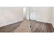 Bright bedroom featuring wood-look flooring and a spacious closet with double doors at 96 Middleton Rd., Andrews, SC 29510