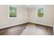 Bedroom with two windows and wood-look flooring for a light and airy feel at 96 Middleton Rd., Andrews, SC 29510