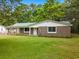 Charming single-story home with stone facade, green roof, and well-maintained lawn at 96 Middleton Rd., Andrews, SC 29510