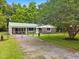Quaint single-story home with a green metal roof, stone accents, fenced yard and covered parking at 96 Middleton Rd., Andrews, SC 29510