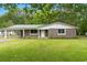 Charming stone and siding home featuring a green metal roof, well-kept lawn, and an attached carport at 96 Middleton Rd., Andrews, SC 29510