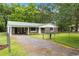 Single-story home boasting stone facade, a green metal roof, an attached carport and fenced in yard at 96 Middleton Rd., Andrews, SC 29510