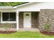 The front porch of a home with brick facade, white door, and well-manicured landscaping at 96 Middleton Rd., Andrews, SC 29510