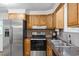 Updated kitchen features stainless steel appliances, granite counters, and wood cabinets at 96 Middleton Rd., Andrews, SC 29510