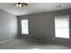 A spacious carpeted bedroom featuring neutral walls and two windows providing ample natural light at 962 Willow Bend Dr., Myrtle Beach, SC 29579