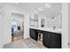 Bright bathroom featuring a double vanity, black cabinets, and white trim at 969 S Waccamaw Dr., Garden City Beach, SC 29576
