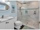 Bright bathroom featuring a glass walk-in shower with marble tile and modern fixtures at 969 S Waccamaw Dr., Garden City Beach, SC 29576