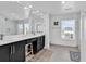 Bright bathroom featuring a double vanity, black cabinets, and large mirror at 969 S Waccamaw Dr., Garden City Beach, SC 29576