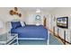 Cozy bedroom features a blue quilt, white furniture, and beach-themed decor at 969 S Waccamaw Dr., Garden City Beach, SC 29576
