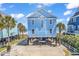 Charming, elevated light blue coastal home with beach views at 969 S Waccamaw Dr., Garden City Beach, SC 29576