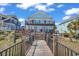 Coastal blue home with multi-level decks and easy access to the beach at 969 S Waccamaw Dr., Garden City Beach, SC 29576