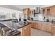 Open kitchen with breakfast bar, granite countertops, stainless steel appliances, and sleek backsplash at 969 S Waccamaw Dr., Garden City Beach, SC 29576