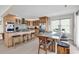 Spacious kitchen with stainless steel appliances, island, and large dining table for a modern aesthetic at 969 S Waccamaw Dr., Garden City Beach, SC 29576