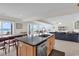 Bright kitchen with island, and ocean view offers a seamless flow into the living area at 969 S Waccamaw Dr., Garden City Beach, SC 29576
