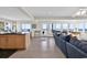 Open-concept living area with ocean views from large windows and sliding doors at 969 S Waccamaw Dr., Garden City Beach, SC 29576