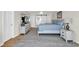 Bright main bedroom featuring a king bed, light colored decor, and white trim at 969 S Waccamaw Dr., Garden City Beach, SC 29576