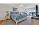 Bright main bedroom featuring a king bed, sitting area, and balcony with ocean view at 969 S Waccamaw Dr., Garden City Beach, SC 29576