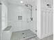 Bright shower with glass door, bench, and rainfall shower head at 969 S Waccamaw Dr., Garden City Beach, SC 29576