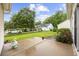 View of backyard with patio, lush green lawn, and view of house and white vehicles at 9831 Winchester Ct., Murrells Inlet, SC 29576