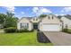 Inviting single-story home featuring tidy landscaping, a spacious lawn, and a convenient attached garage at 9831 Winchester Ct., Murrells Inlet, SC 29576