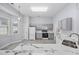 Kitchen with white marble countertops, stainless sink, and gray cabinets at 9831 Winchester Ct., Murrells Inlet, SC 29576
