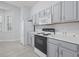 Kitchen with white appliances, gray cabinets, and wood-look floors at 9831 Winchester Ct., Murrells Inlet, SC 29576
