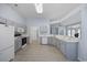 Spacious kitchen with gray cabinets, white appliances, and wood-look floors at 9831 Winchester Ct., Murrells Inlet, SC 29576