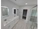 Bright bathroom features double vanity, tile floors, and sleek lighted mirrors at Tbd 7 Duford Rd., Nichols, SC 29581