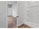 Bathroom featuring a white shower and view to the hallway at 1004 Sentinel Ct., Little River, SC 29566