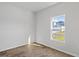 Bright bedroom with wood-look floors and a window offering natural light at 1004 Sentinel Ct., Little River, SC 29566