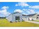 Single-story home with light blue siding, a well-manicured lawn, and an attached one car garage at 1004 Sentinel Ct., Little River, SC 29566