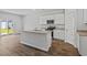 Bright kitchen with white cabinets, granite countertops, a central island, and stainless steel appliances at 1004 Sentinel Ct., Little River, SC 29566