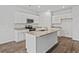 Modern kitchen with white cabinets, granite countertops, stainless steel appliances, and a kitchen island at 1004 Sentinel Ct., Little River, SC 29566