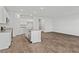 Open-concept kitchen with white cabinets, granite countertops, a central island, and hardwood floors at 1004 Sentinel Ct., Little River, SC 29566