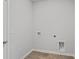 Laundry room with light grey walls, hardwood floors, and standard utility hookups at 1004 Sentinel Ct., Little River, SC 29566