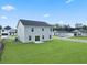 Spacious backyard featuring newly installed grass, a small patio, and a view of neighboring homes at 1013 Kinness Dr., Conway, SC 29527