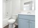Well-lit bathroom features a blue vanity, white countertop, toilet, and shower-tub combo at 1013 Kinness Dr., Conway, SC 29527