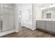 Modern bathroom showcasing wood-look flooring, tub, and glass shower at 1013 Kinness Dr., Conway, SC 29527
