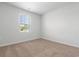 Bright bedroom with neutral carpet, large window, and fresh white walls at 1013 Kinness Dr., Conway, SC 29527