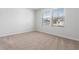 Bright bedroom with neutral carpet, large window, and fresh white walls at 1013 Kinness Dr., Conway, SC 29527