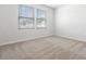Comfortable bedroom with plush carpeting and natural light from two windows at 1013 Kinness Dr., Conway, SC 29527